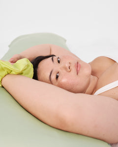 model with silk pillowcase in sage
