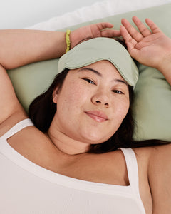 model with silk sleep mask in sage
