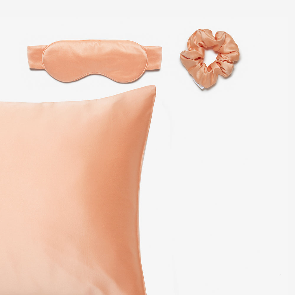 silk pillowcase, silk sleep mask and silk scrunchie in peach