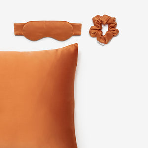 silk pillowcase, silk sleep mask and silk scrunchie in terracotta